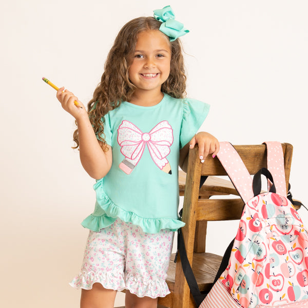 young girl wearing back to school outfit