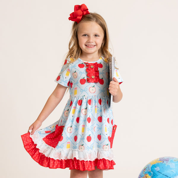 young girl wearing back to school dress