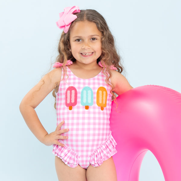 girl wearing popsicle one piece swimsuit