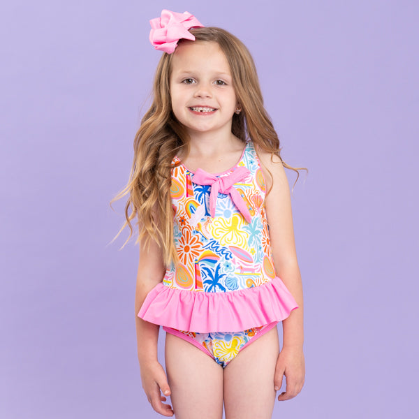 girl wearing colorful one piece swimsuit