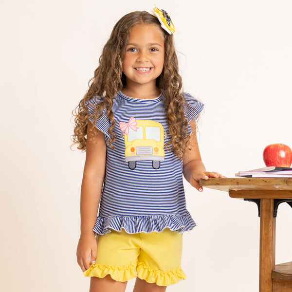 young girl wearing back to school school bus outfit