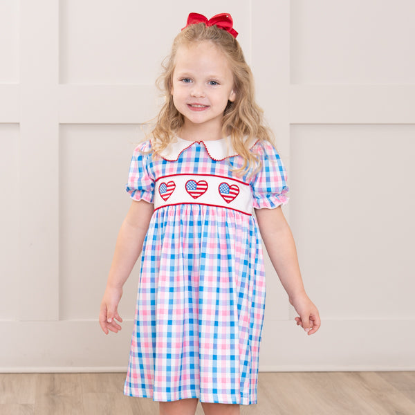 young girl wears gingham patriotic dress