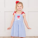 young girl wears baseball dress