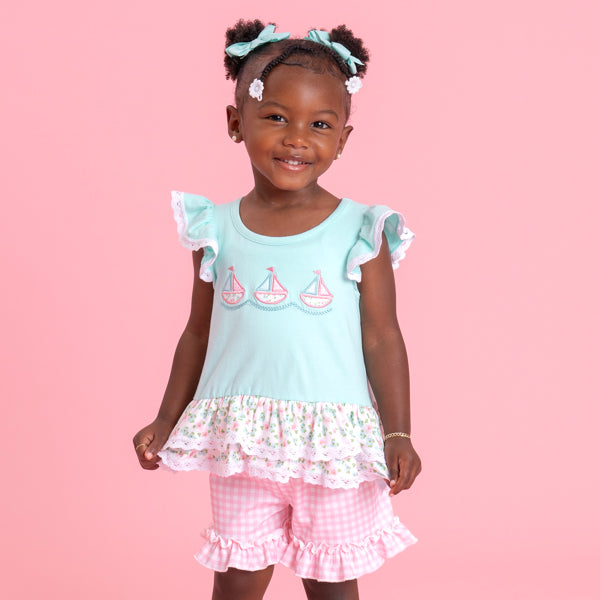 young girl wears sailboat outfit