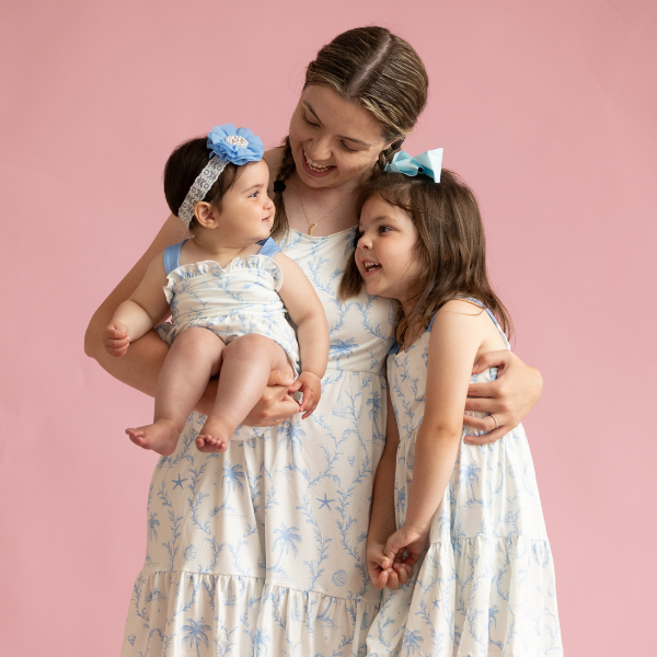 mom with young daughters in matching outfits