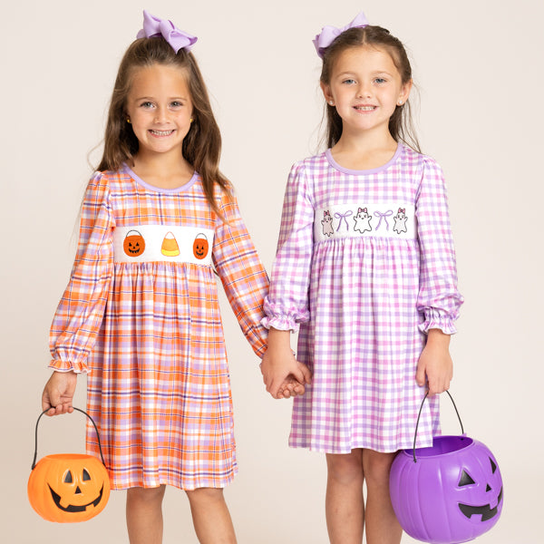 two girls wear halloween dresses