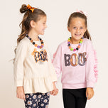 two girls wear Halloween outfits